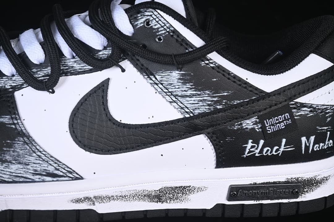 Close-up of the side swoosh, brushstroke panels, and layered laces