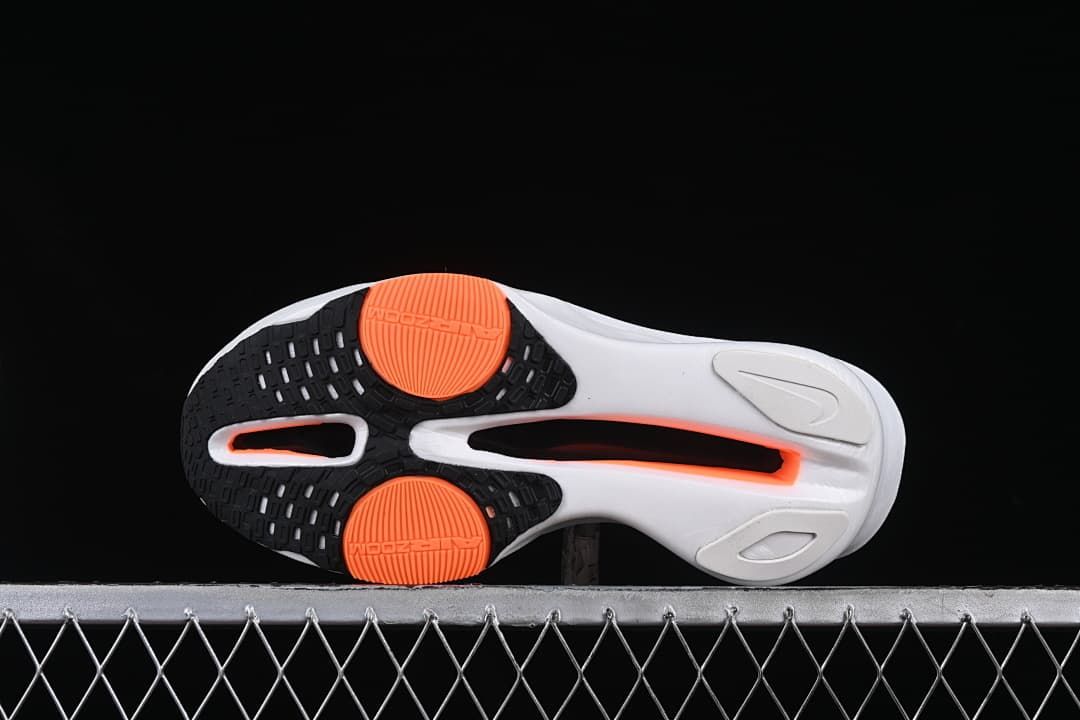 Underside view showing black, white and orange outsole sections