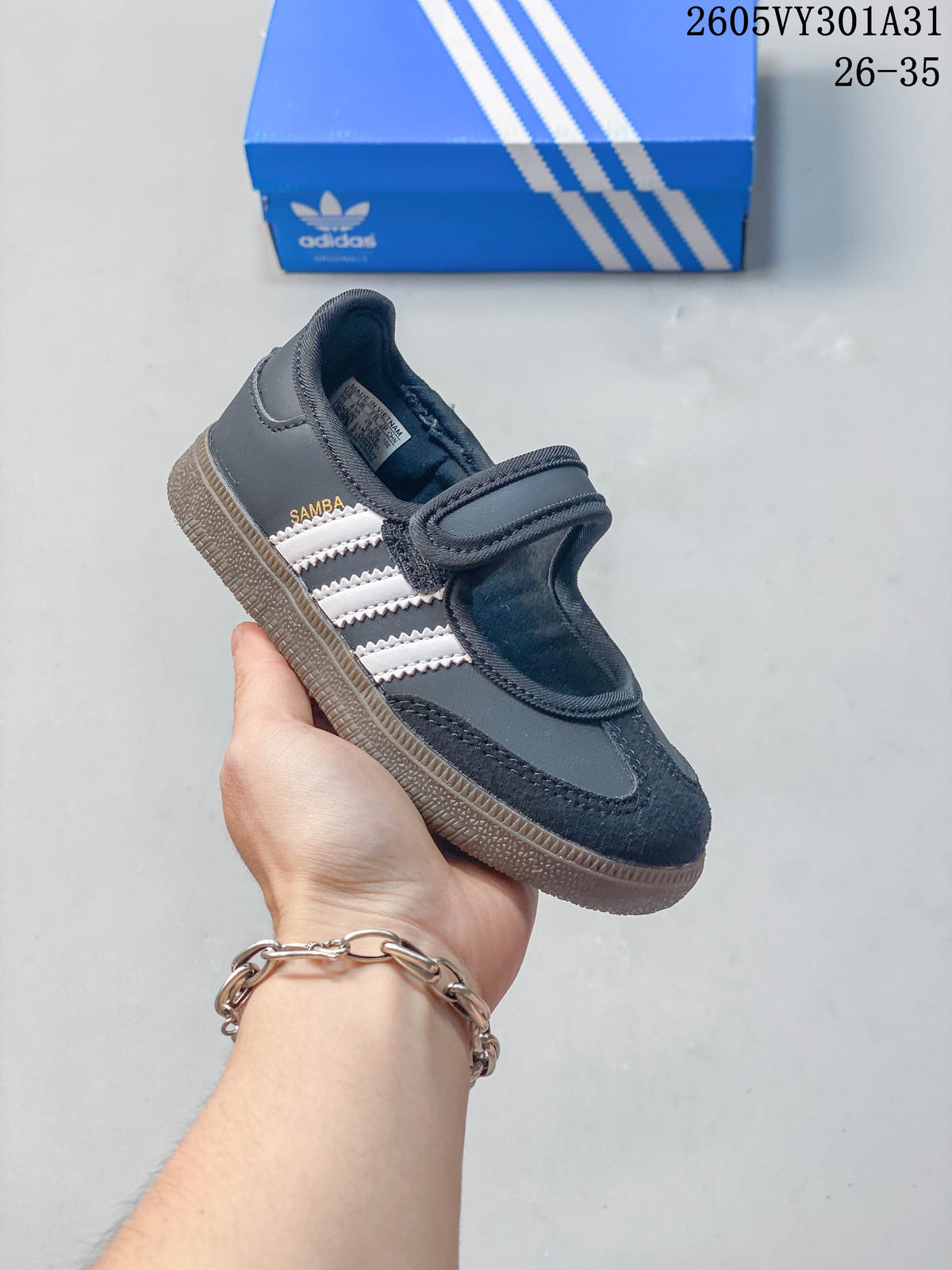 Dark gray kids’ Samba Jane shoe with white side stripes