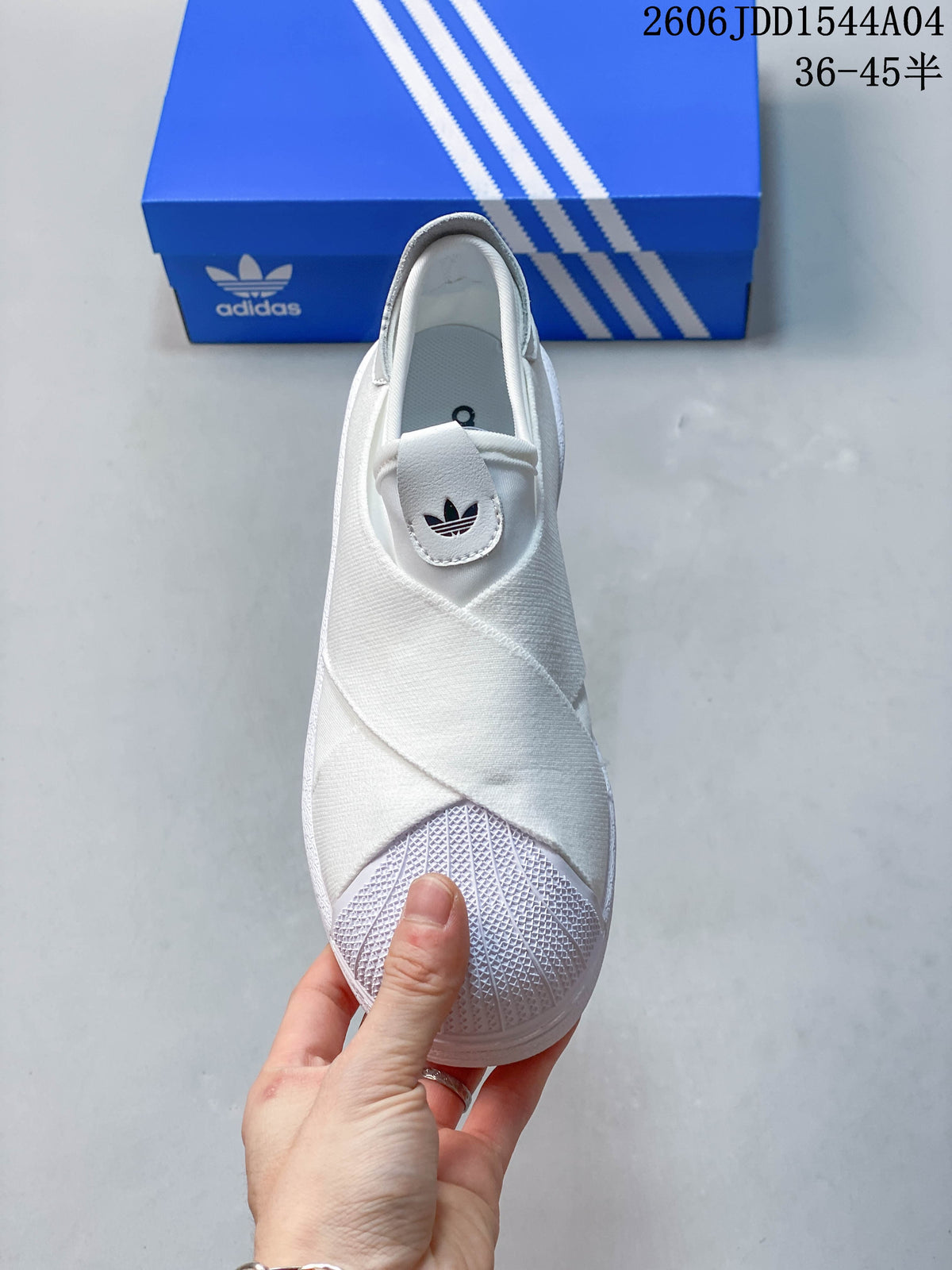 Top view of the white sneaker showing its crossing bands and shell-toe detail.