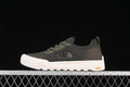 Side view of an army green and dark gray low-top sneaker with a white sole