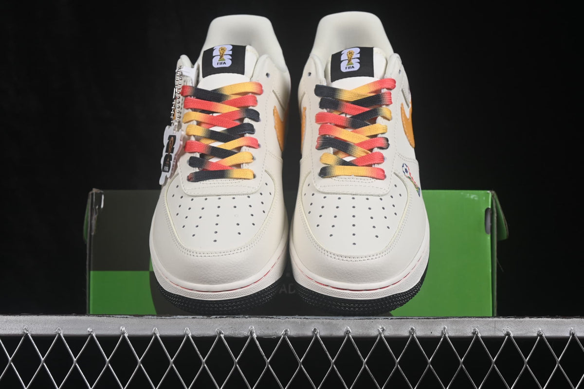 Front view of the pair with white uppers, multicolor laces, and black outsoles.