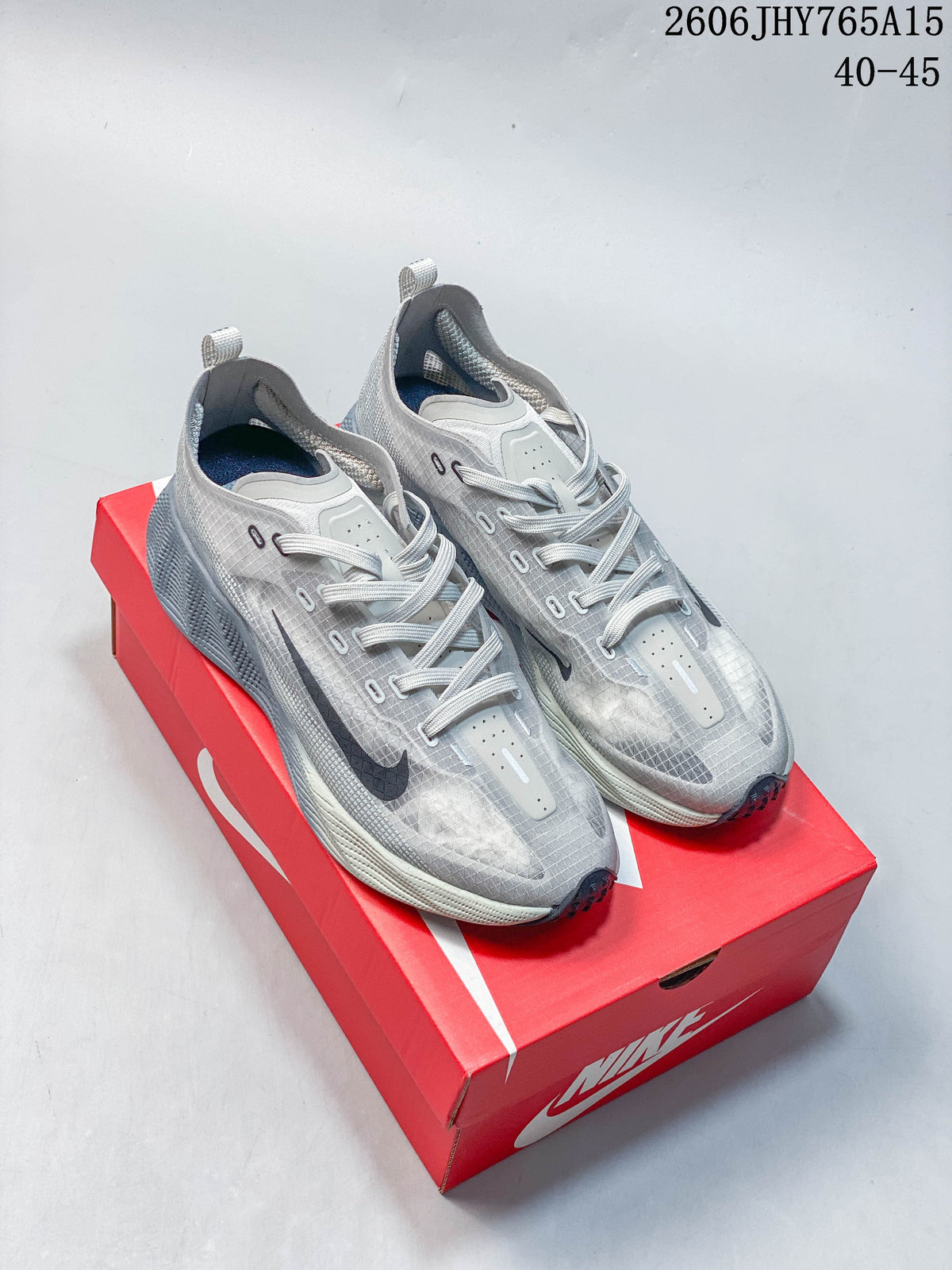 Pair of grey Nike Ava Rover low-top running shoes shown from above on a red shoe box