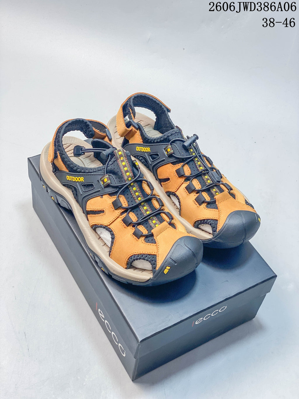 Orange and dark navy ECCO closed-toe outdoor sandals shown from above on a box.