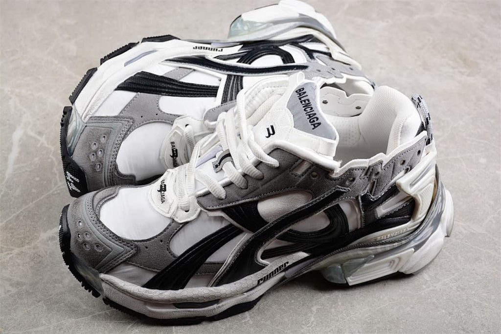 Pair of grey, white, and black Runner sneakers shown from above