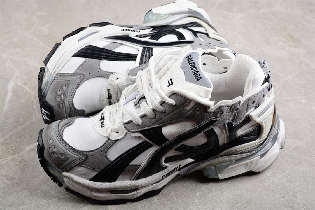Pair of grey, white, and black Runner sneakers shown from above