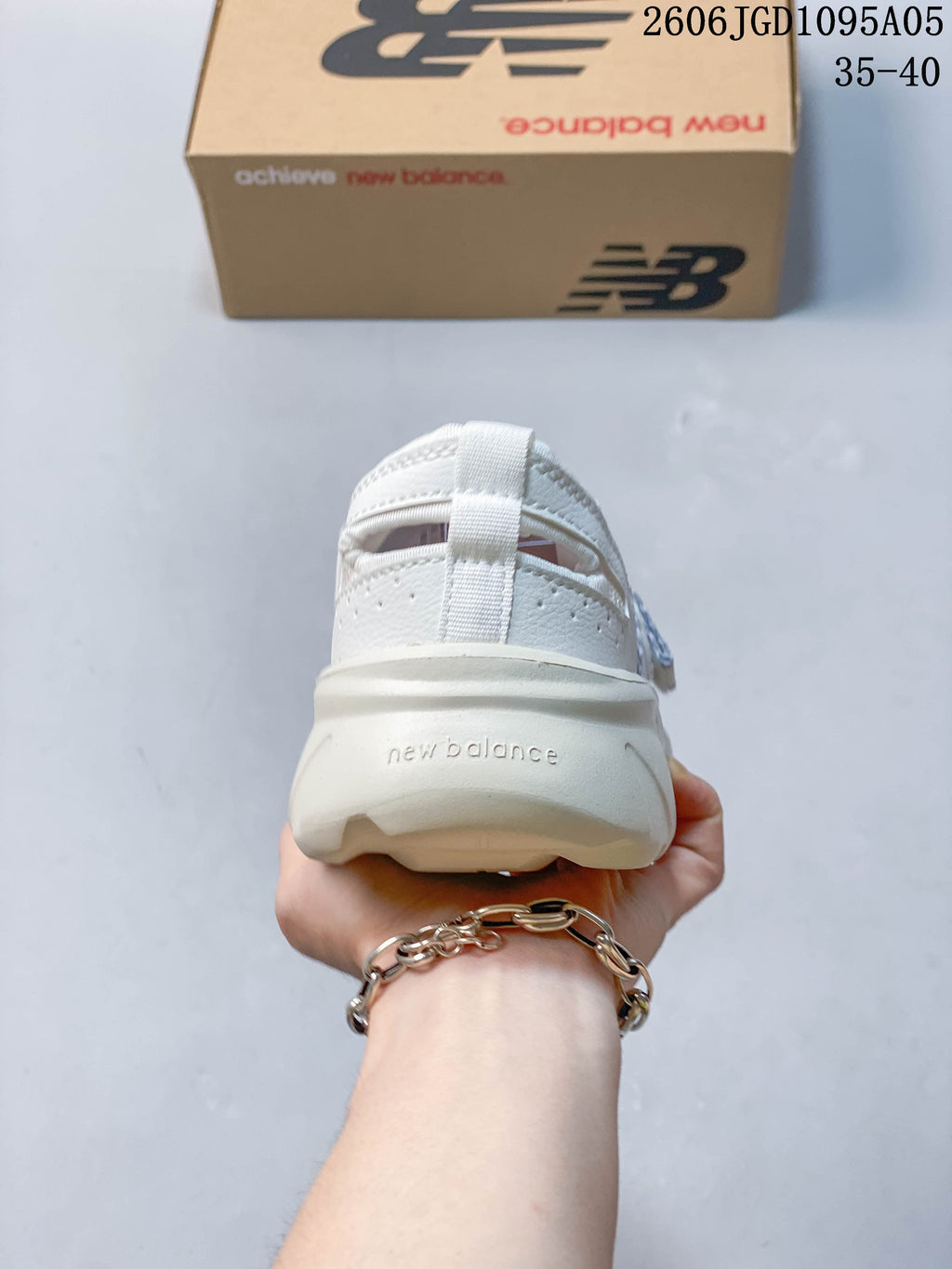 Rear view of a white New Balance Breeze sneaker showing the heel and pull tab