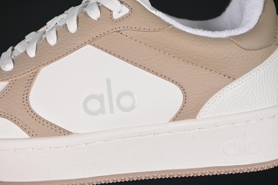 Close-up of the side logo, beige overlays, and white sole