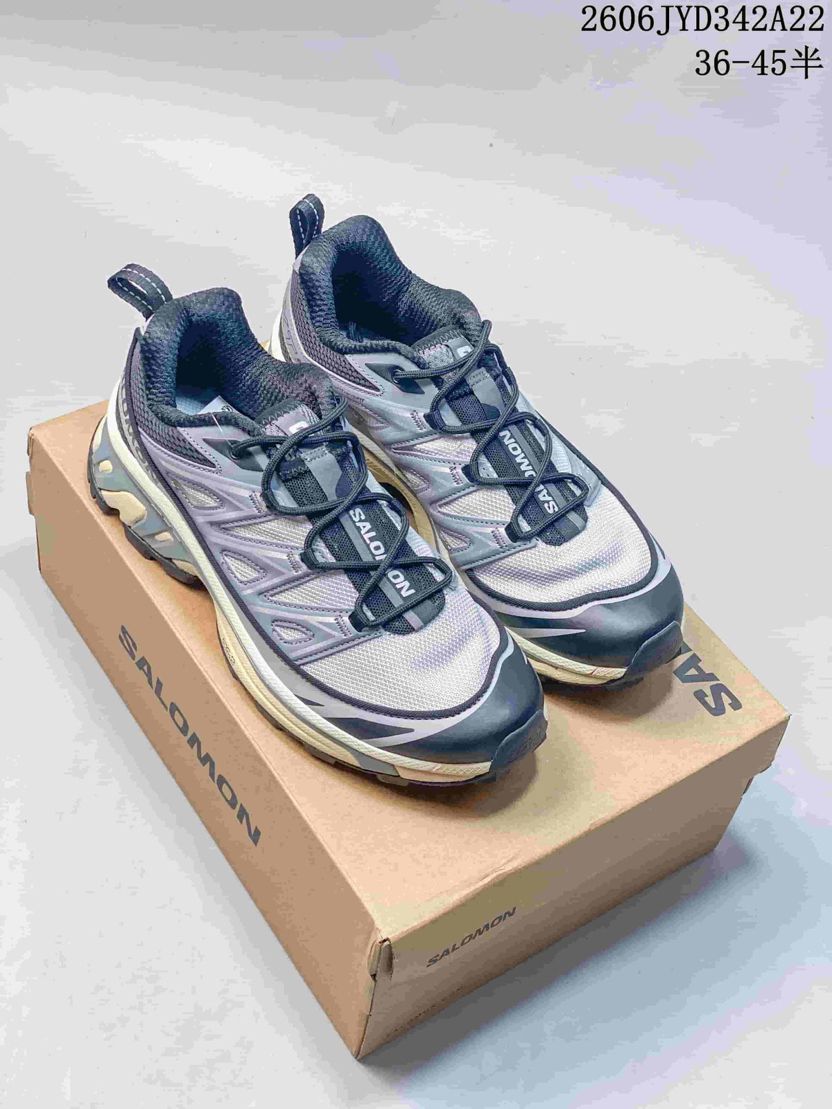 Pair of gray and white Salomon mesh sneakers with dark accents