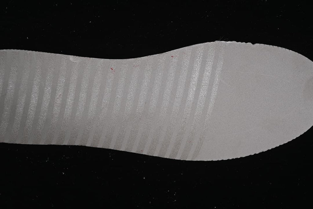 Close-up of the light-colored sneaker outsole