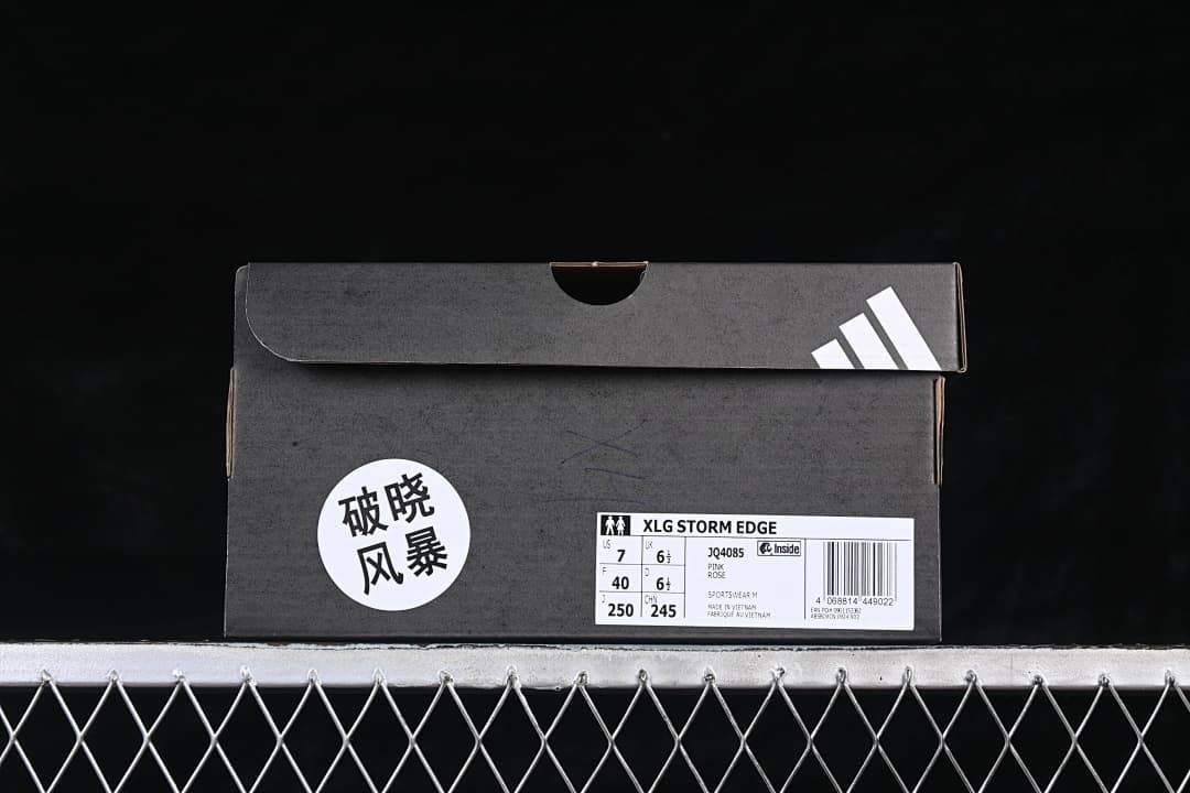 Shoe box label identifies the XLG Storm Edge and style code JQ4085; sample size markings are visible