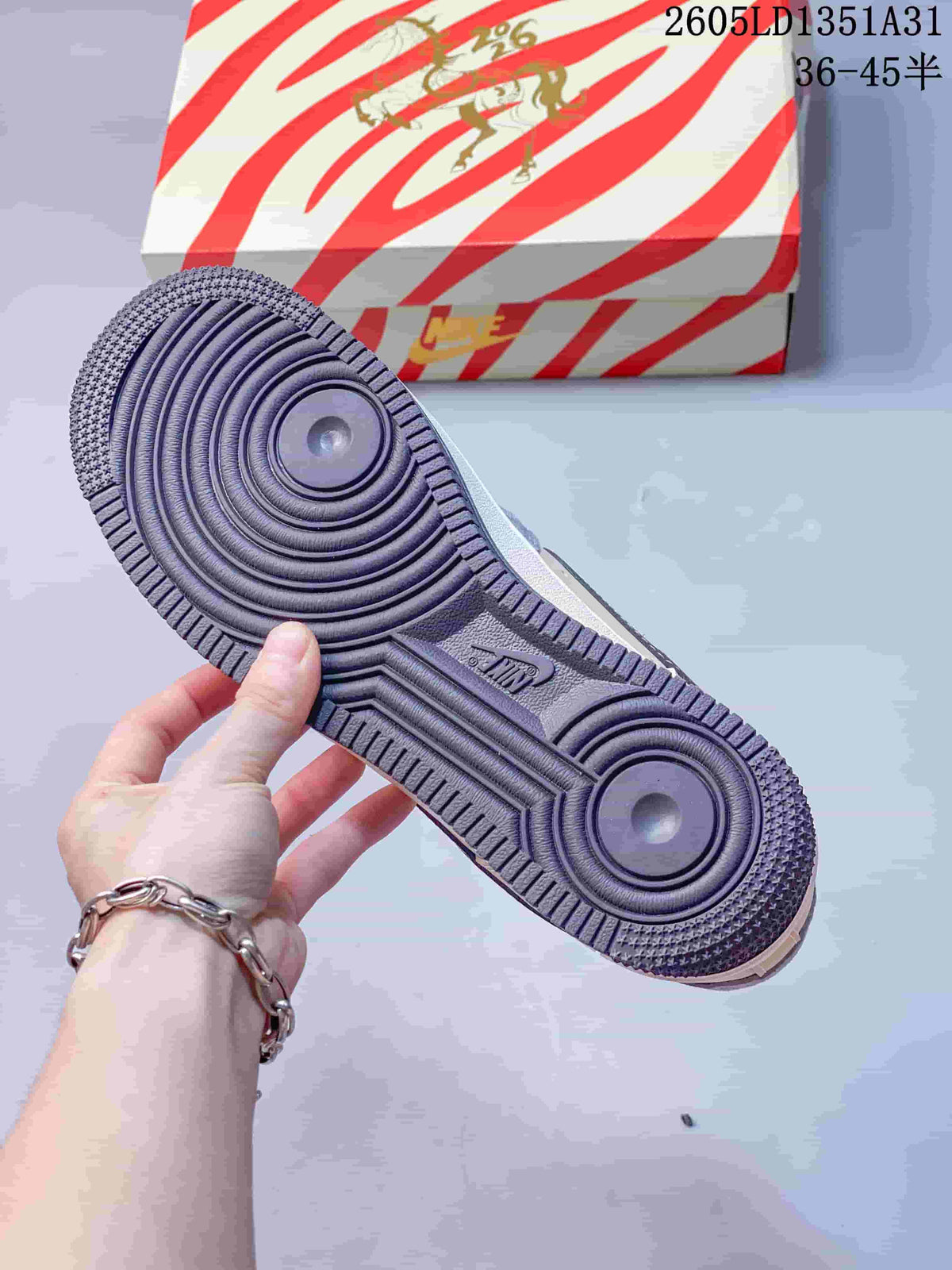 View of the gray outsole and horse-themed striped shoe box