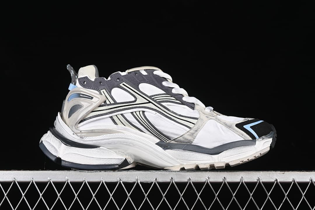Side profile of the sneaker showing its layered panels and sculpted sole.