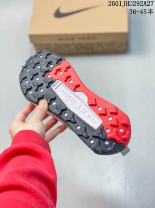 Underside view showing the black-and-red lugged outsole and its patterned traction surface.