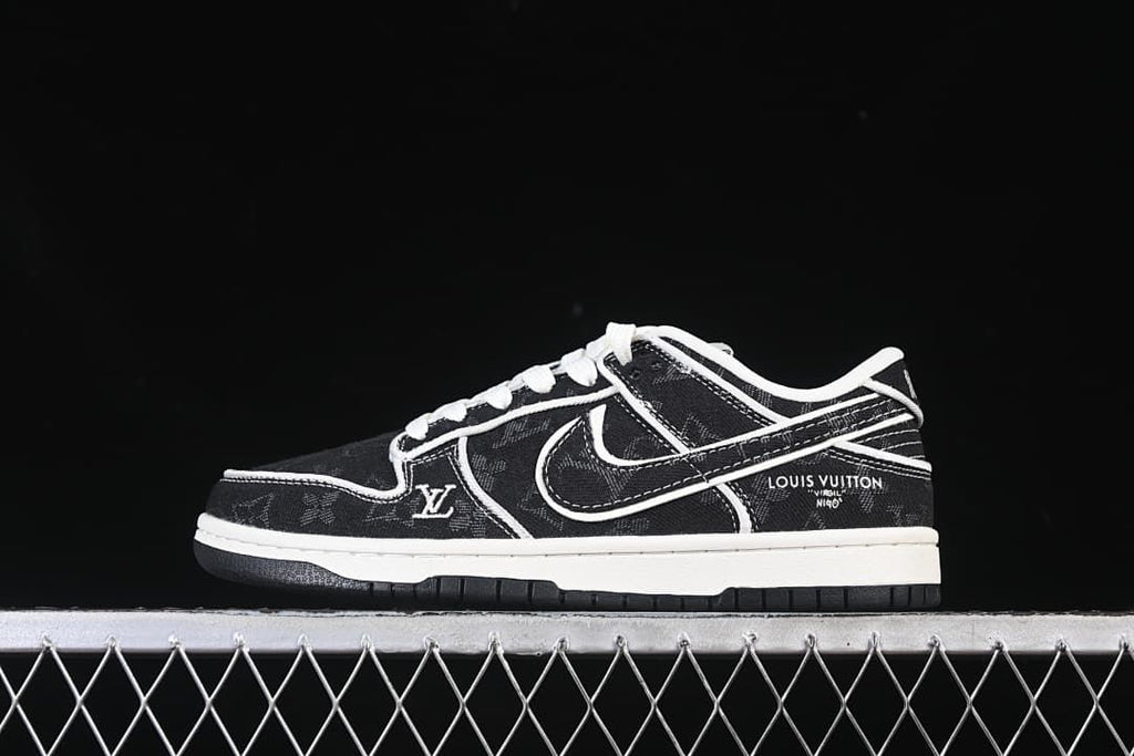 Side view of black patterned SB Dunk Low-style sneaker with white stitching and a white midsole