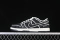 Side view of black patterned SB Dunk Low-style sneaker with white stitching and a white midsole
