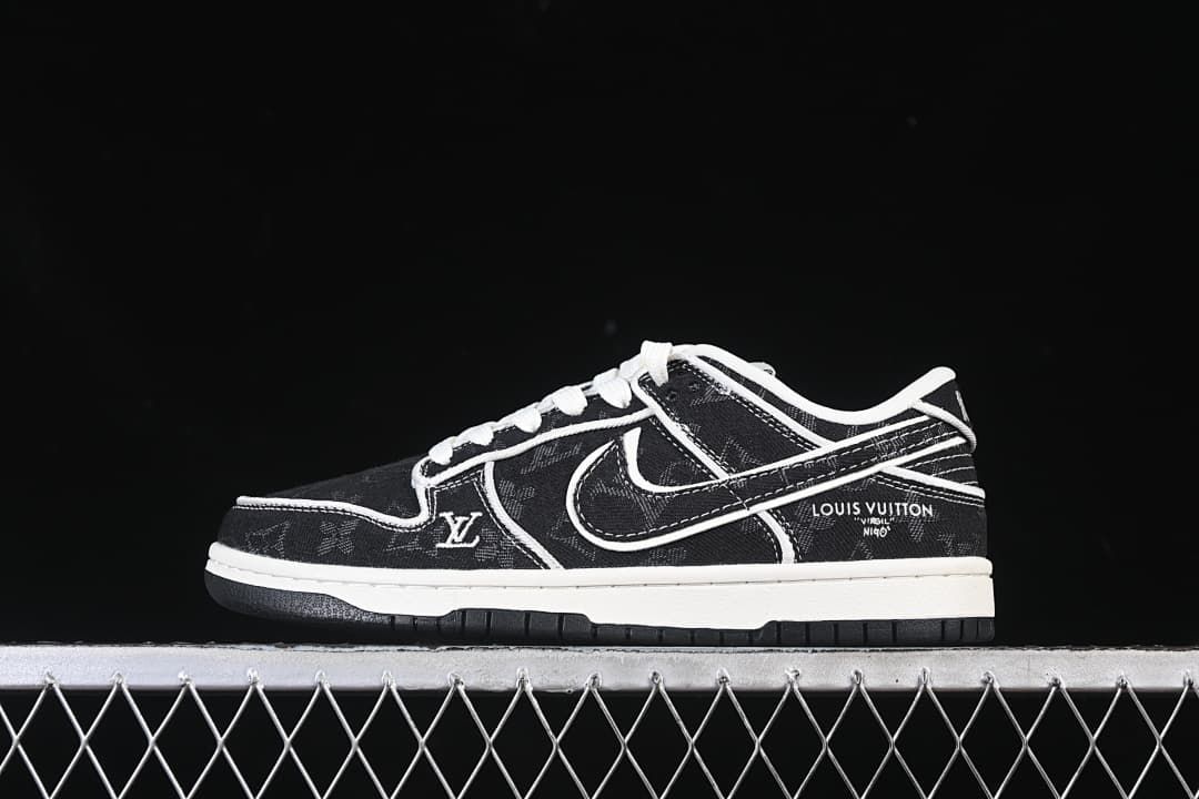 Side view of black patterned SB Dunk Low-style sneaker with white stitching and a white midsole