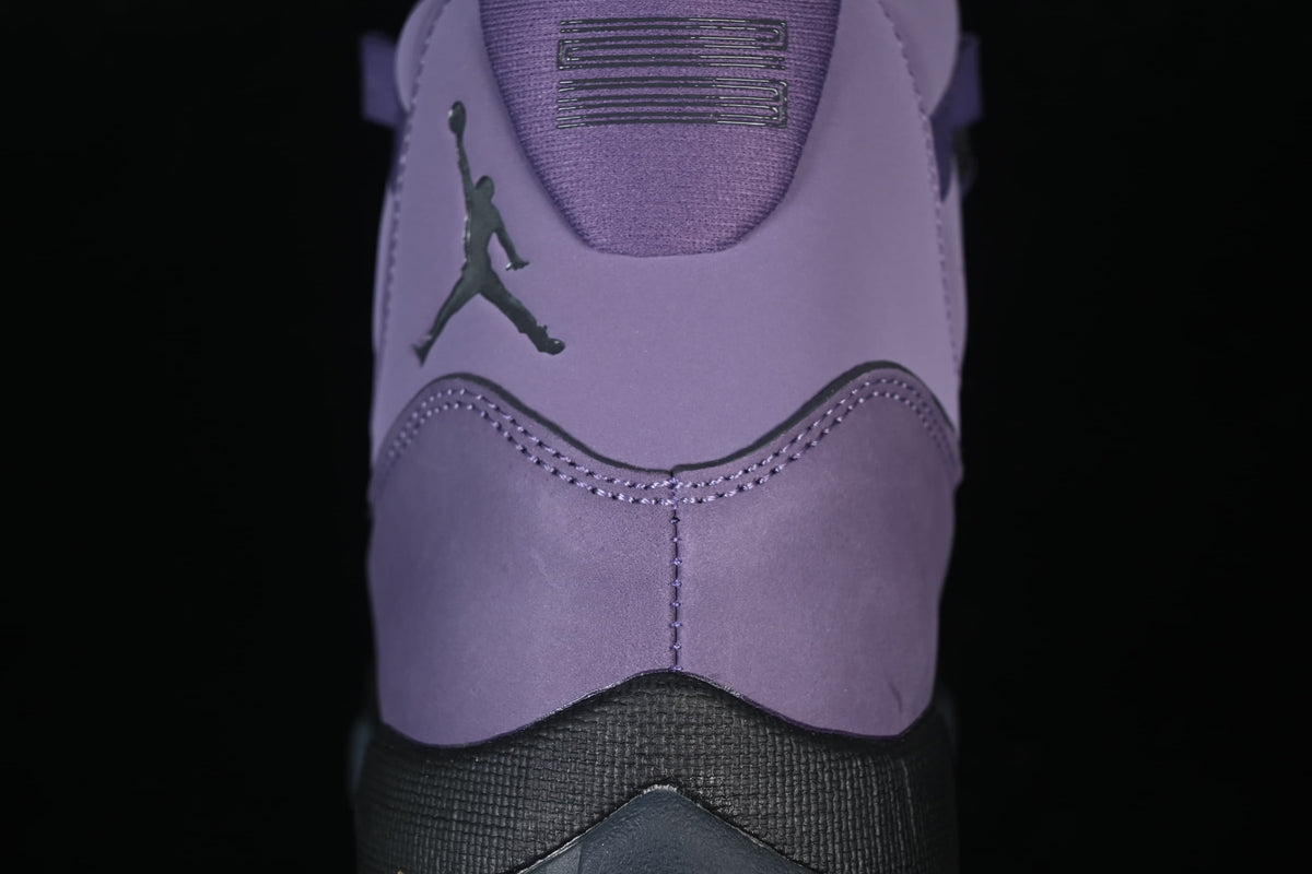 Close-up of the heel with a dark Jumpman logo and stitched purple panels.
