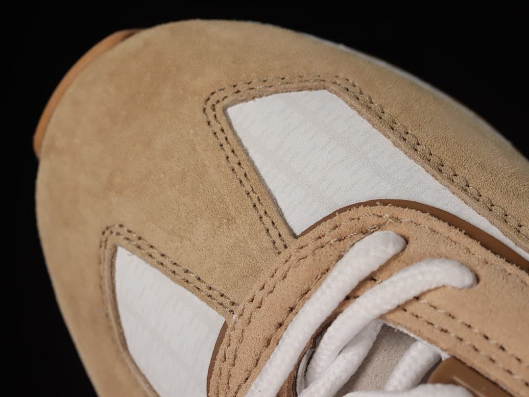 Close-up of the sneaker's beige toe and white lace area