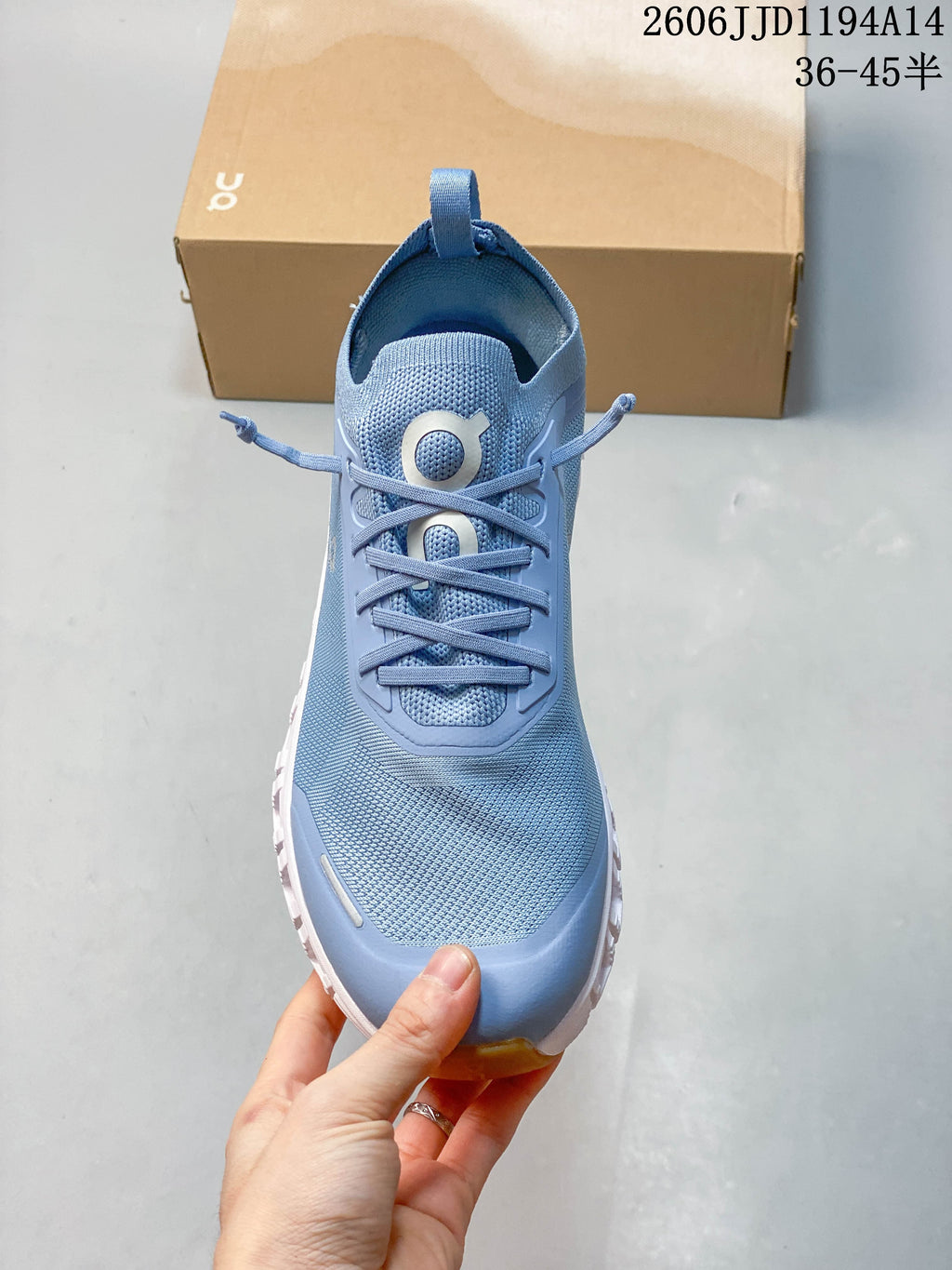 Front view of a blue sneaker showing its mesh-look upper and laces.