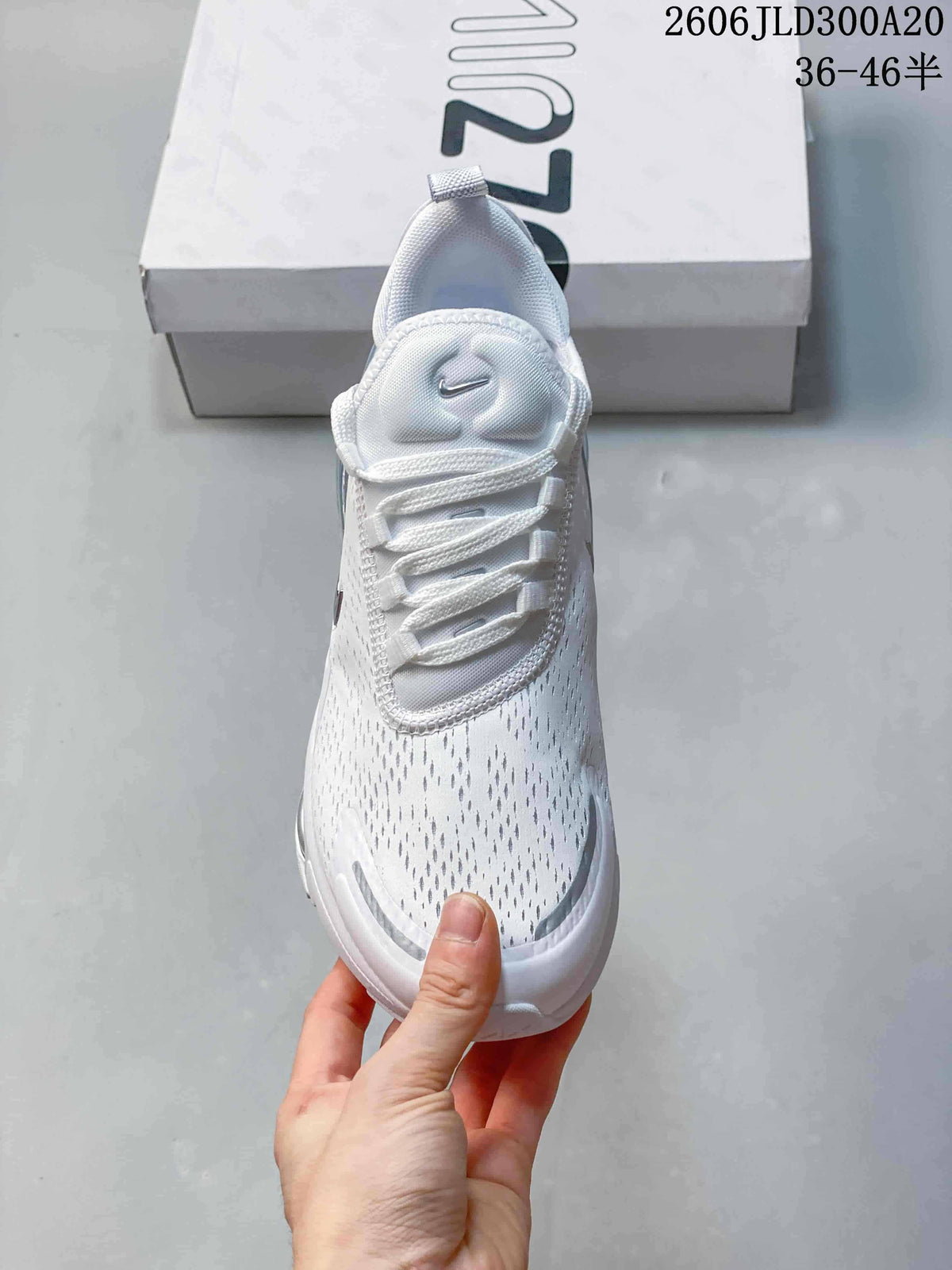 Top view of the perforated-looking upper and laces on a white Air Max 270 sneaker