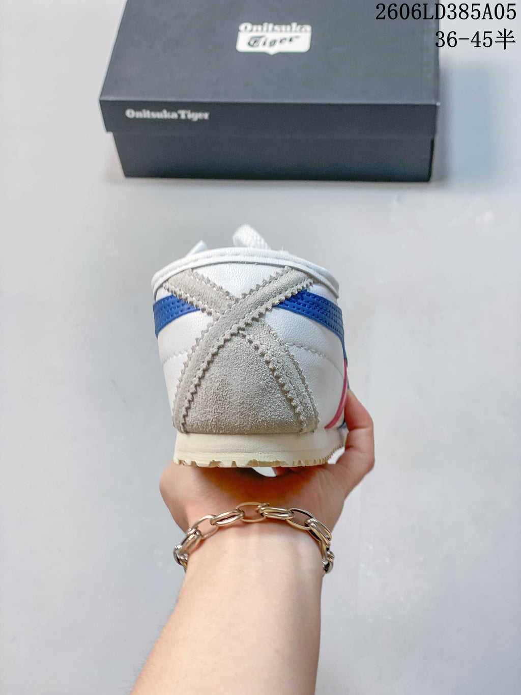 Rear view of the sneaker showing grey heel overlays and blue accents.