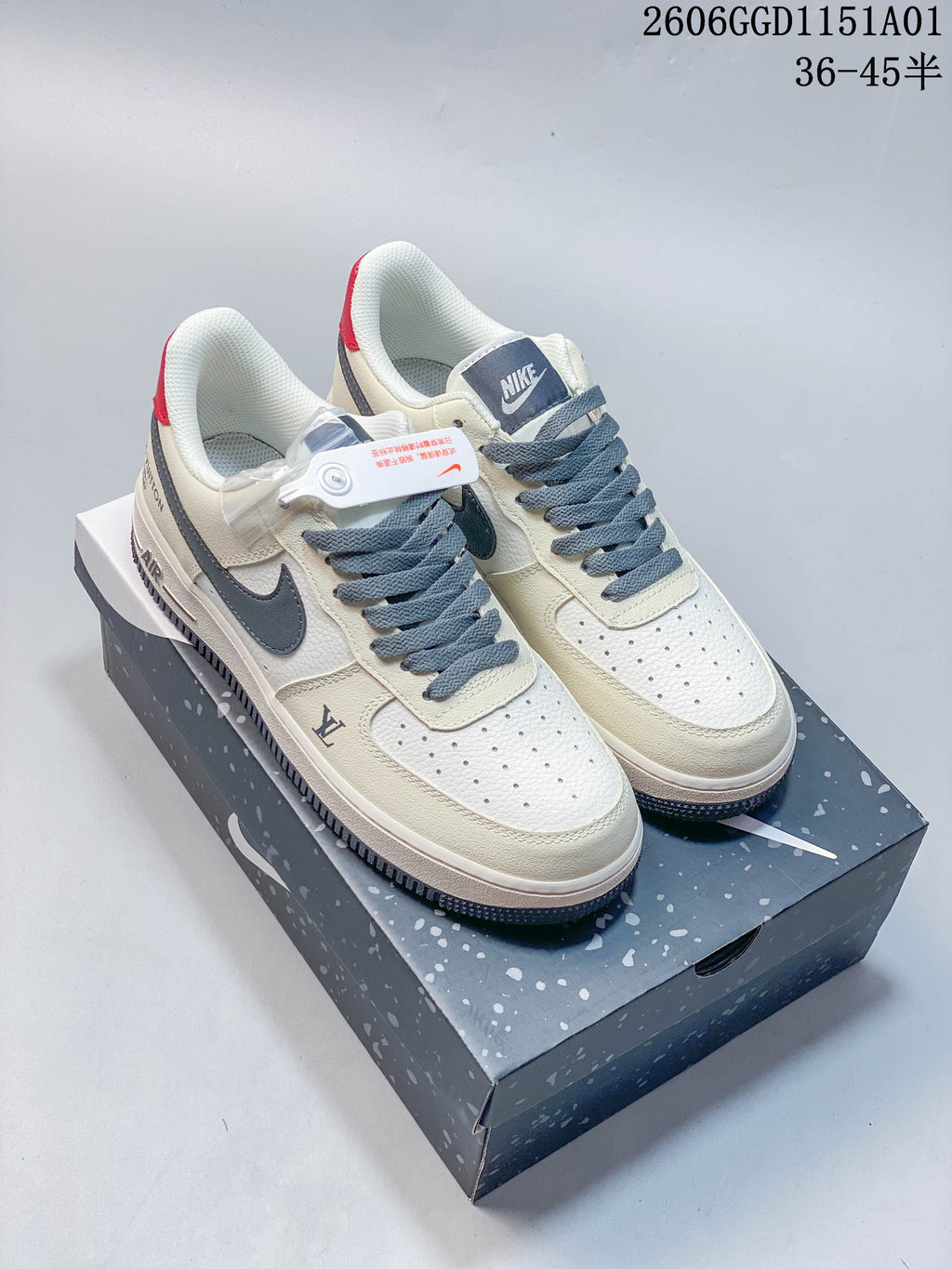 Pair of off-white and gray-blue Nike Air Force 1 '07 LV8 low-top sneakers with red heel details, shown on a Nike shoebox.