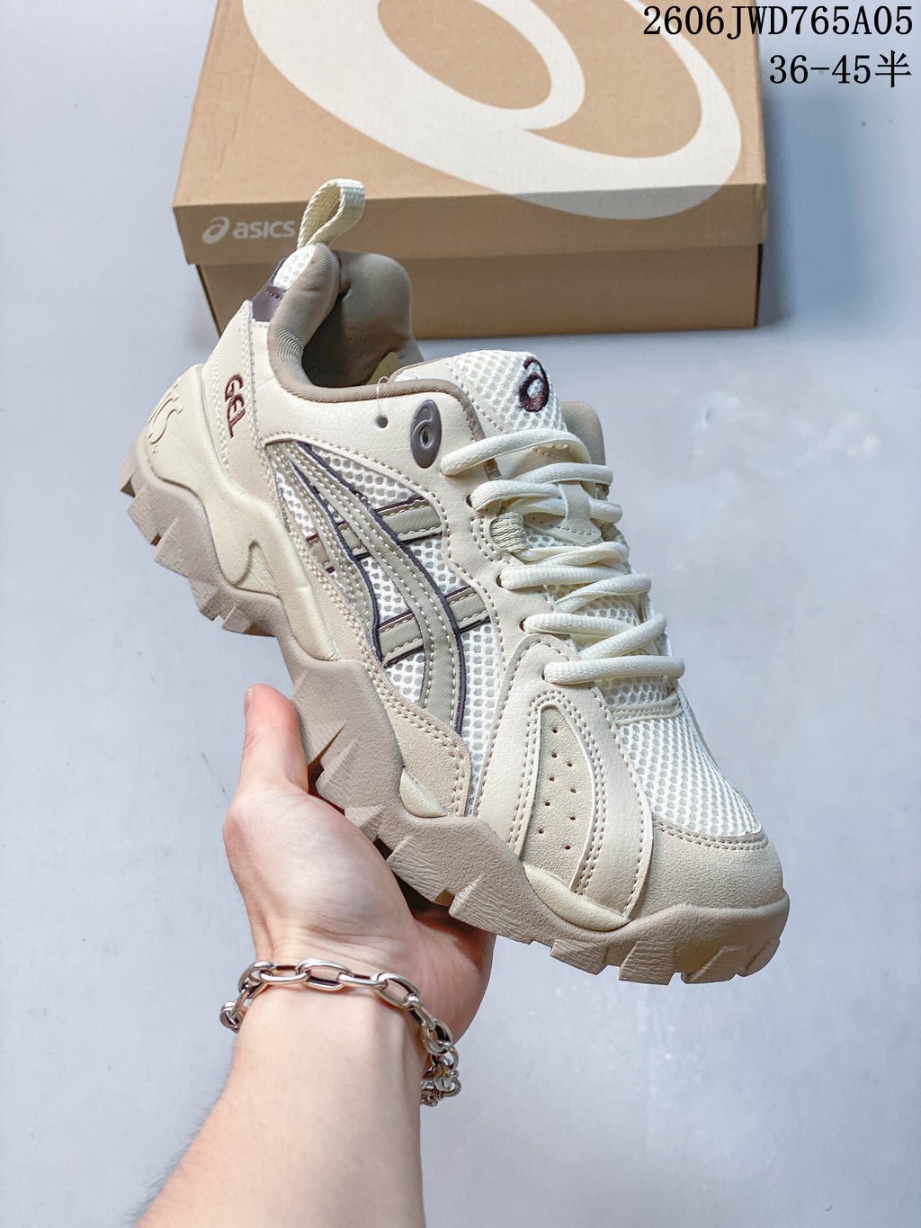 Angled side view of a cream ASICS Gel-TRUCK sneaker with dark accents
