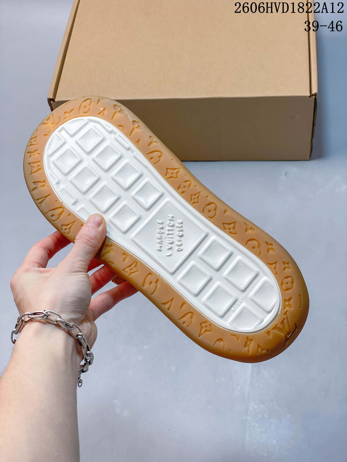 Underside of the sneaker showing a white center tread and gum-colored patterned outsole.