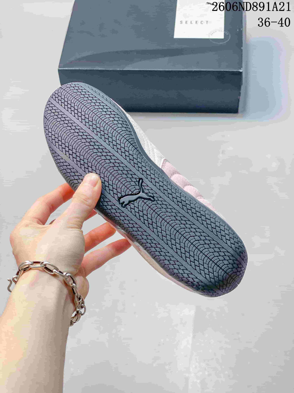 Close-up of the patterned dark outsole on a pink Puma Speedcat OG sneaker