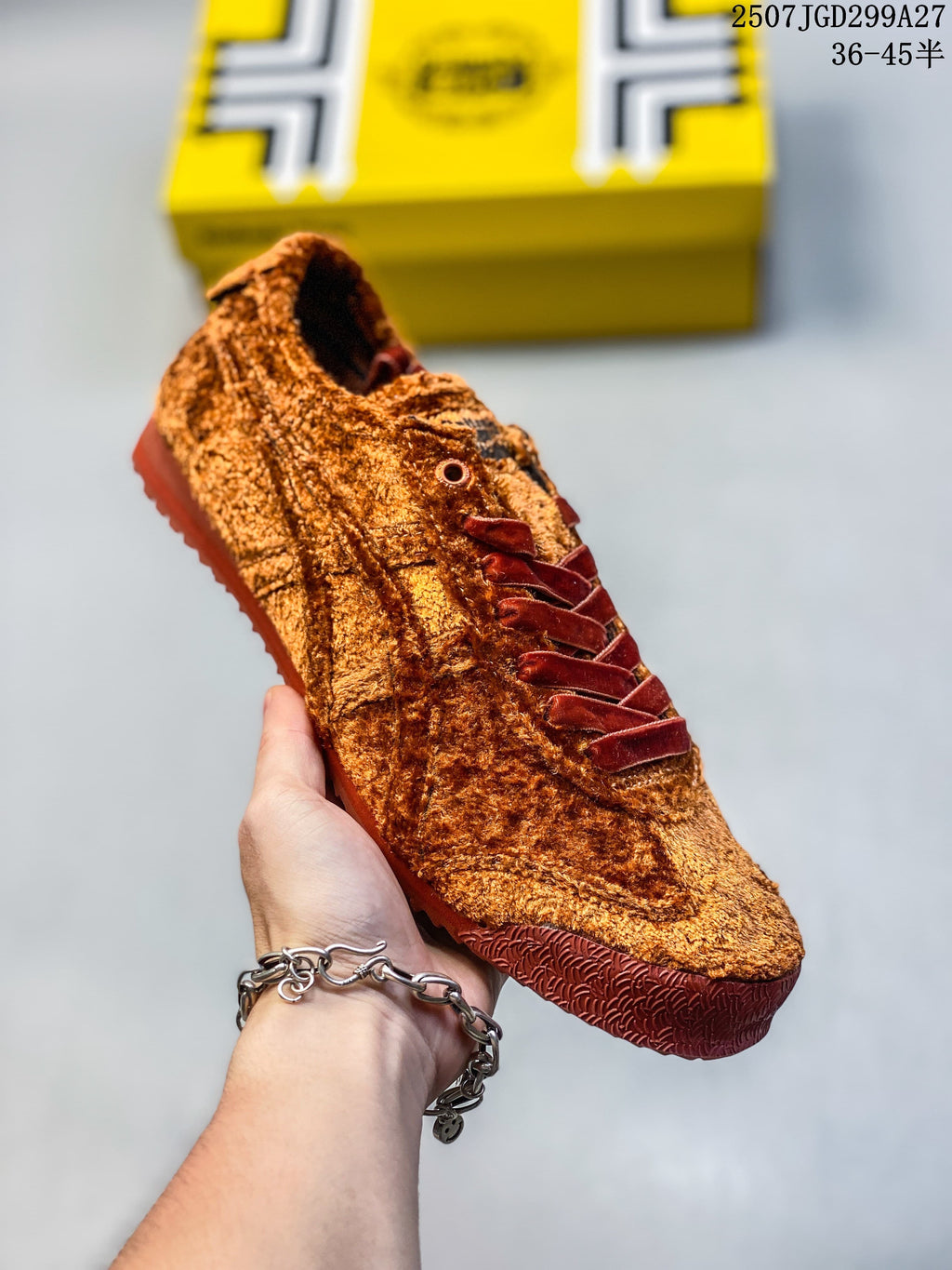 Angled close-up of the rust-brown sneaker, including its laces and side detailing