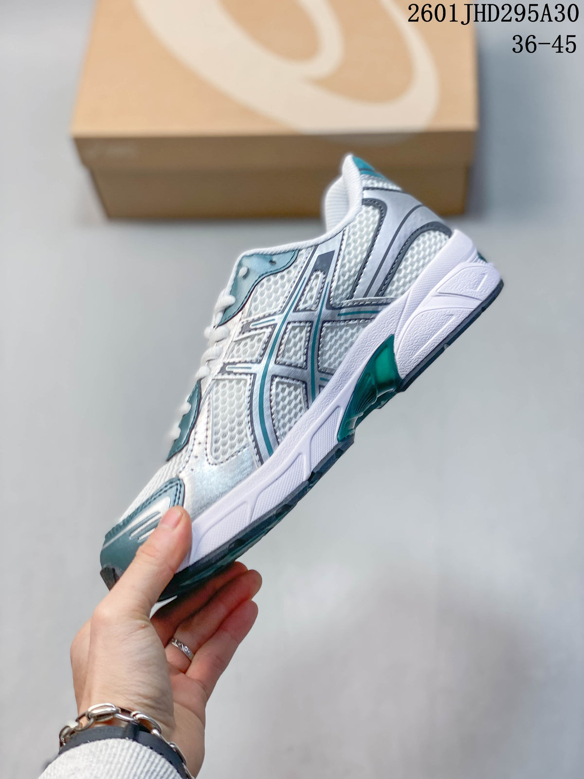 Side profile highlighting the mesh-look upper and silver and teal overlays