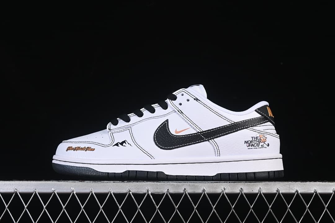 Side view of a white low-top sneaker with black laces, a black swoosh, contrast stitching, and outdoor-themed graphics.