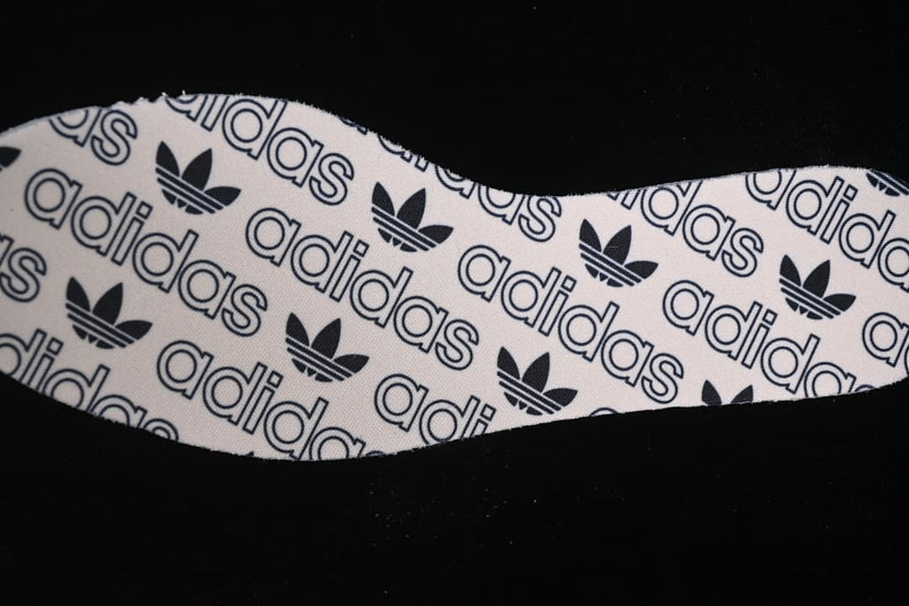 Close-up of the insole printed with adidas text and Trefoil logos.
