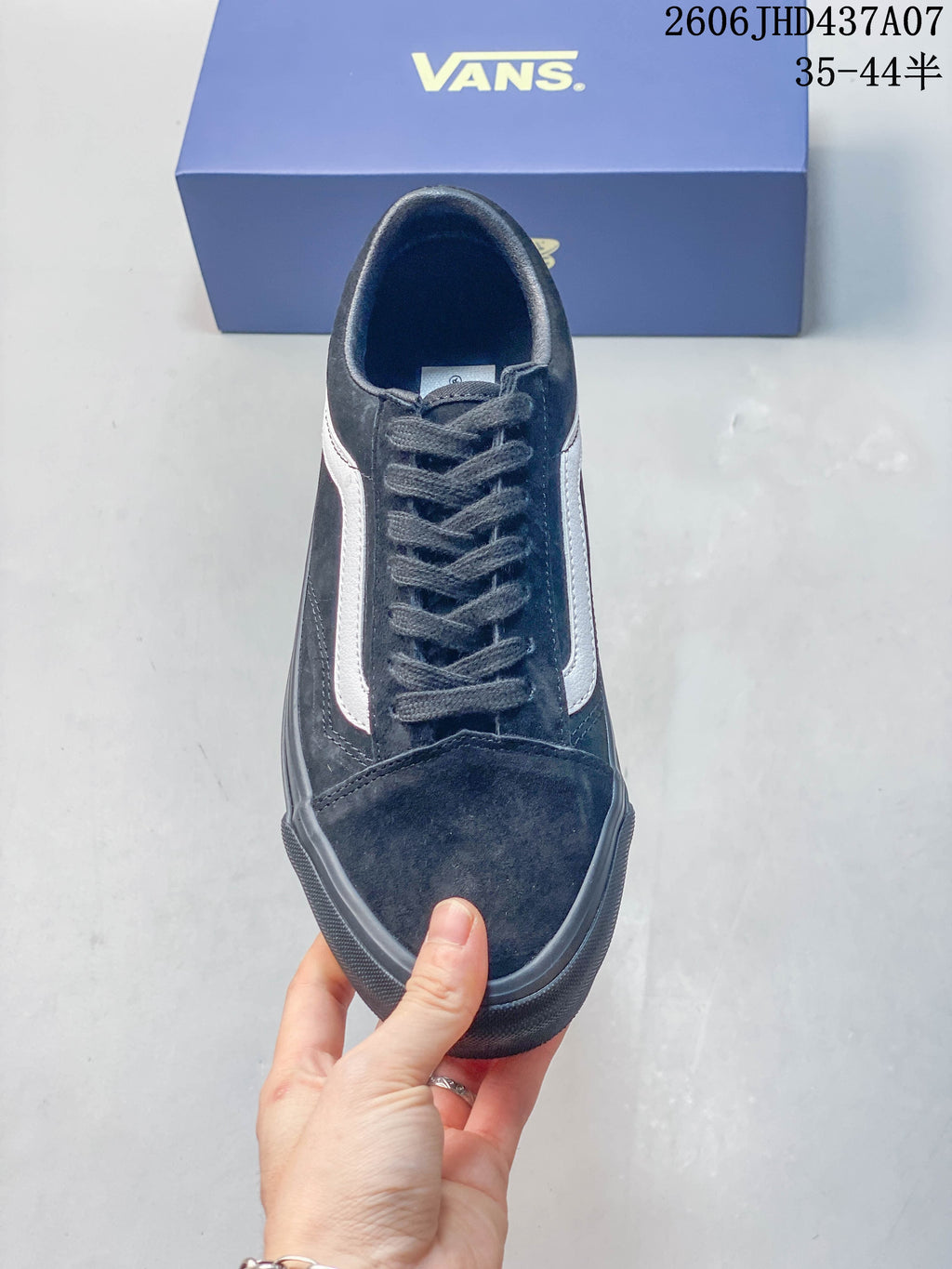 Front view of the black lace-up sneaker with white side stripes.