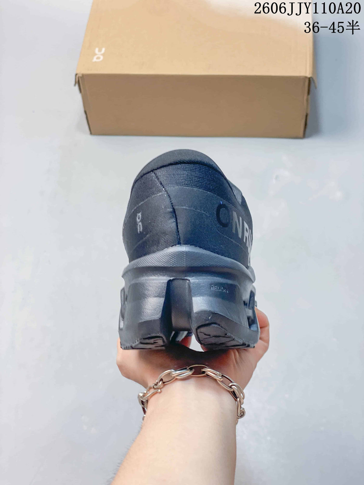 Rear view of a dark gray On shoe highlighting the heel and sculpted outsole.