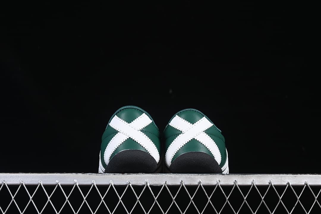 Rear view of both sneakers showing white crossed heel panels and black soles.