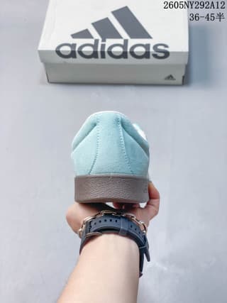 Rear view showing the padded heel, pale sea blue upper, and gum-colored sole.