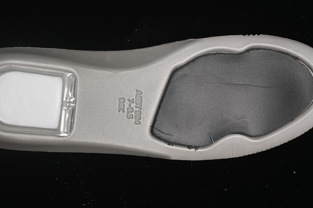 Underside of the shoe insole with visible size marking 7.5 and other printed codes