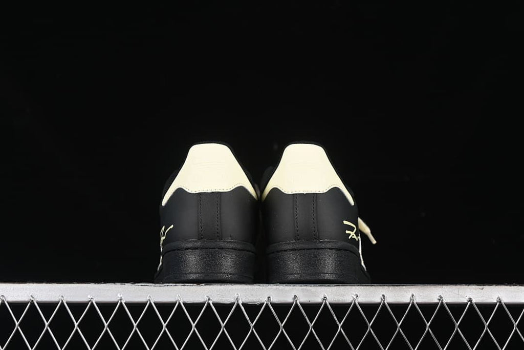 Rear view of both sneakers with cream heel tabs.