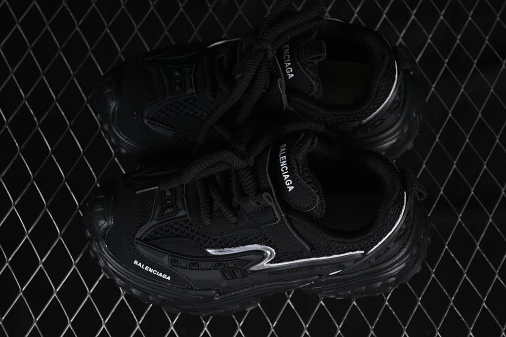 Pair of black children's sneakers viewed from above.