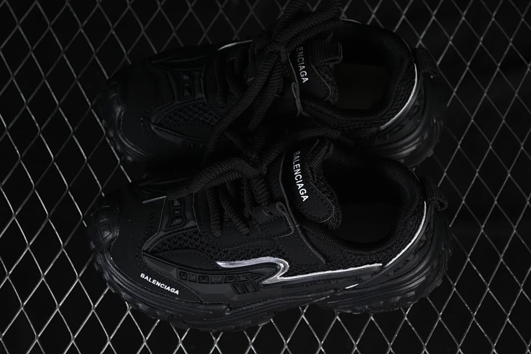 Pair of black children's sneakers viewed from above.