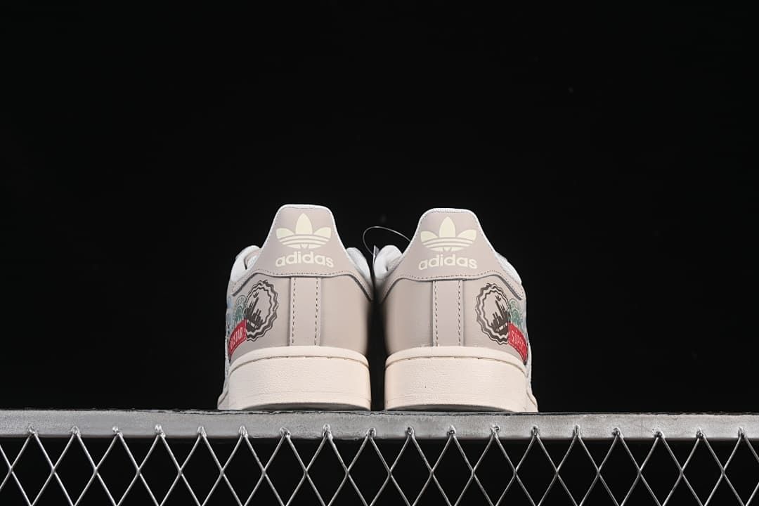 Rear view of both sneakers showing heel branding and graphic accents.