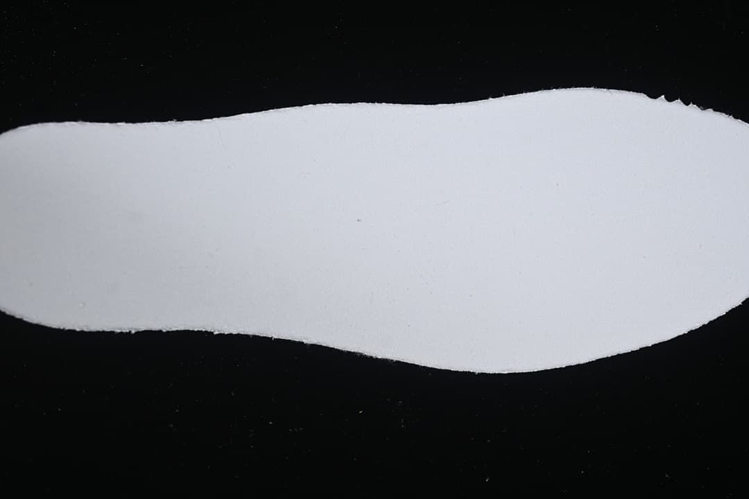 White shoe insole shown against a dark background