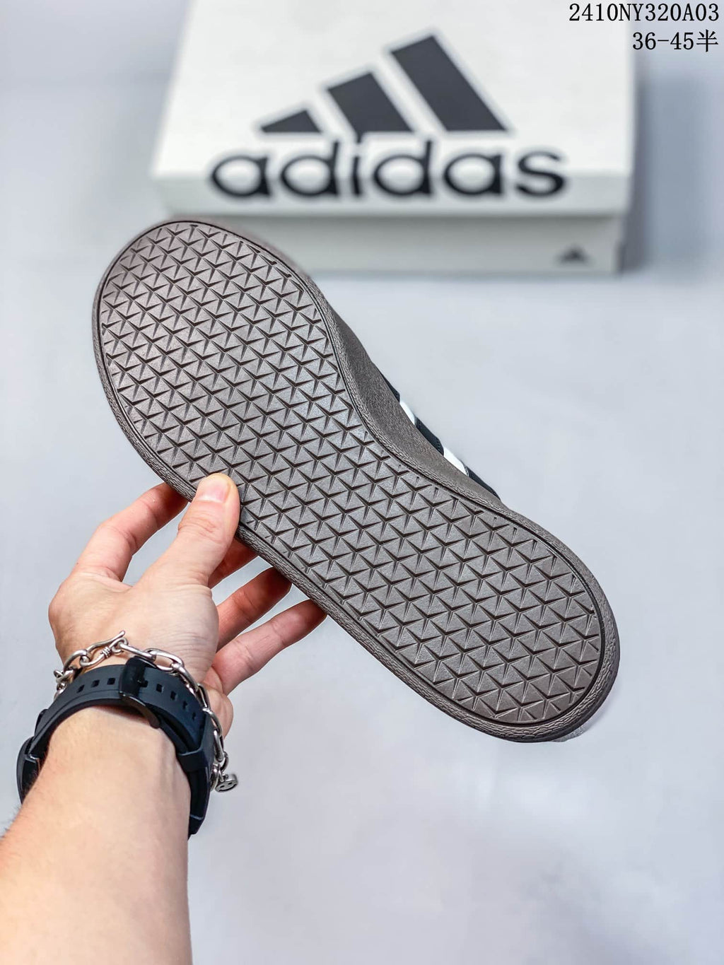 Close-up of the dark brown sneaker outsole showing its geometric tread pattern