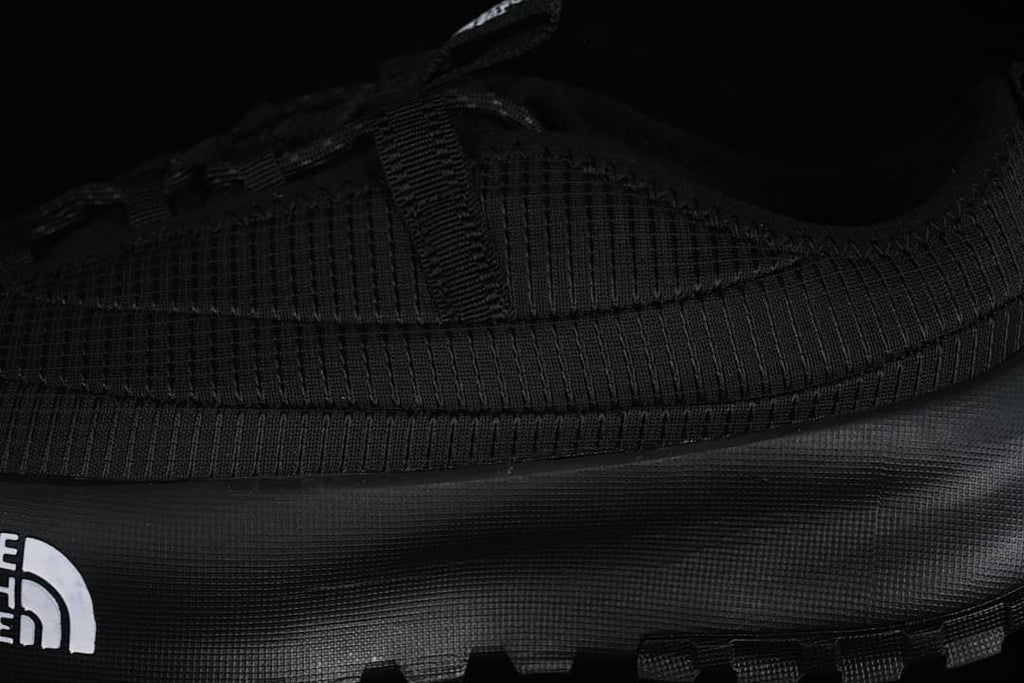 Close-up of the black upper, side panel, and outsole