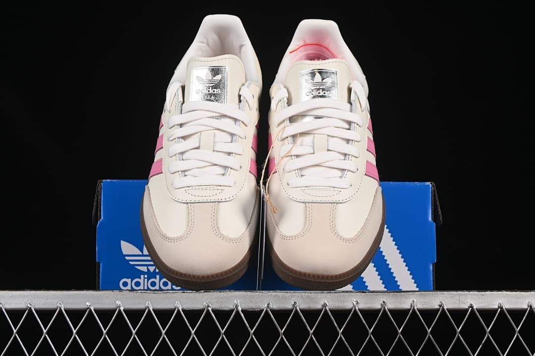 Front view of the pair showing white laces, pink stripes, and gum toe edges
