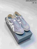 Pair of gray Onitsuka Tiger slip-on sneakers with white side stripes and striped heel panels