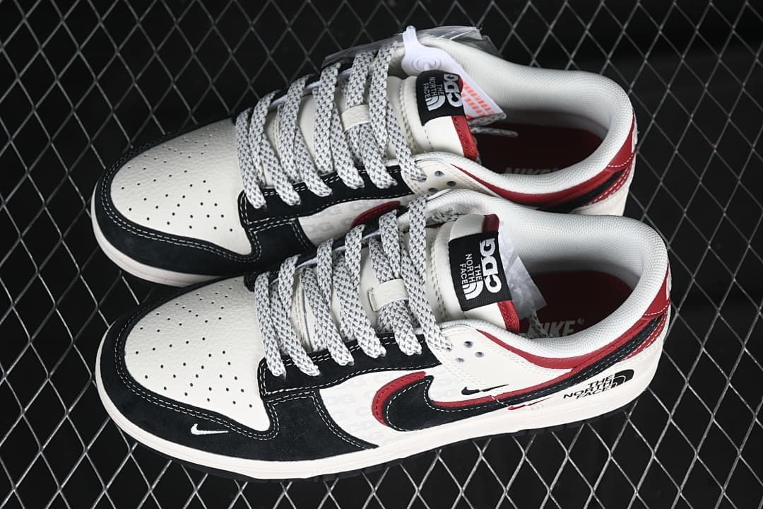 Pair of white, black, and red low-top sneakers viewed from above