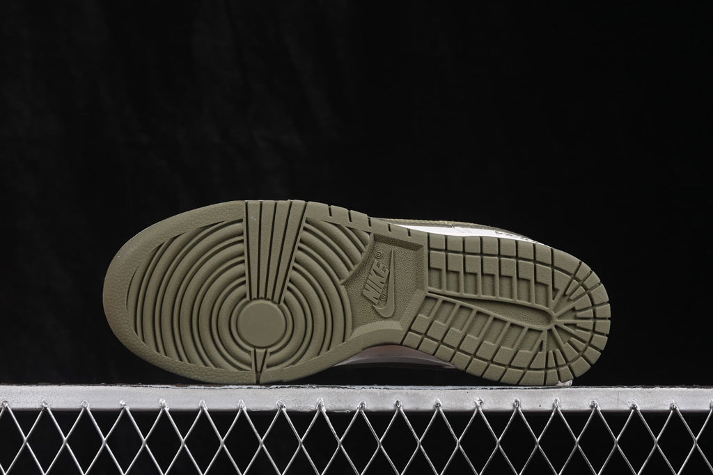 Bottom view showing the olive rubber outsole with circular and geometric traction patterns.